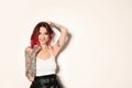 Beautiful woman with tattoos on arms against background. Space for text