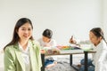 beautiful woman teacher smile, happy, look at camera with cute children or student at background in education classroom. asian Royalty Free Stock Photo