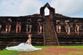 Beautiful woman in Thai traditional dress sitting