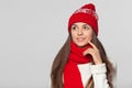 Beautiful woman thinking looking to the side at blank copy space. Winter concept smile girl wearing knitted warm hat and scarf Royalty Free Stock Photo