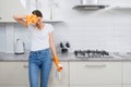 Beautiful woman tired after cleaning kitchen.