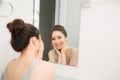 Beautiful woman touching her face by hands in her bathroom Royalty Free Stock Photo