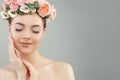 Beautiful woman touching her face her hand. Pretty candid girl with flowers. Facial treatment, face lifting, anti aging