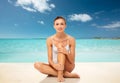 Beautiful woman touching her smooth legs on beach Royalty Free Stock Photo