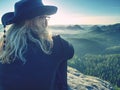 Beautiful woman tourist enjoy daybreak on sharp of rock Royalty Free Stock Photo