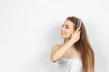 Beautiful woman in a towel combing hair.