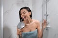 Beautiful woman with towel singing while taking shower Royalty Free Stock Photo