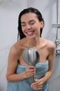 Beautiful woman with towel singing while taking shower Royalty Free Stock Photo