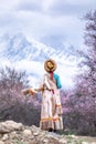 Beautiful woman in traditional Chinese clothes on top of the hill overlooking the Namcha Barwa mount Royalty Free Stock Photo