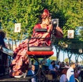 Beautiful woman in traditional and colorful dress travelling in a horse drawn carriages at the April Fair, Seville Fair