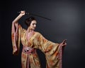 Beautiful woman in traditional Japanese kimono with katana Royalty Free Stock Photo