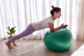 beautiful woman training pilates with fitness ball