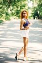 Beautiful woman training in a summer park