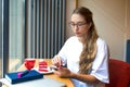 Beautiful woman in trendy glasses checking e-mail on mobile phone Royalty Free Stock Photo