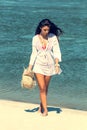 Beautiful woman on tropical beach, Brunette tanned girl enjoying and walking on beach