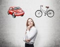 A beautiful woman is trying to chose the most suitable way for travelling or commuting. Two sketches of a car and a bicycle are dr
