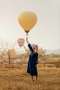 Beautiful Woman Trying To Reach Hot Air Balloon In Sky With Hand Royalty Free Stock Photo