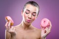 Beautiful woman with two donuts. You may eat or not? Royalty Free Stock Photo