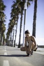 Beautiful woman tying shoes on a bike lane in Barcelona beach & x28;SPAIN