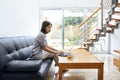 Beautiful woman typing on laptop at modern cozy home Royalty Free Stock Photo