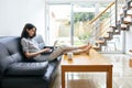 Beautiful woman typing on laptop at modern cozy home