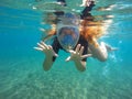 Beautiful woman under water snorkeling in mask, red hair girl snorkeling Royalty Free Stock Photo