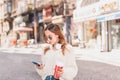 Beautiful woman uses smartphone while walking Royalty Free Stock Photo