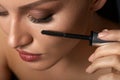 Beautiful Woman Using Black Mascara On Closed Eyes Royalty Free Stock Photo