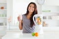 Beautiful woman using a blender