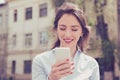 Beautiful woman using her mobile phone in the street. Royalty Free Stock Photo