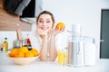 Beautiful woman using juicer for making orange juice Royalty Free Stock Photo