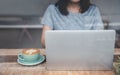 Beautiful woman using laptop at cafe. Confident young woman in smart casual wear working on laptop while sitting near window in cr Royalty Free Stock Photo