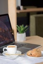 Beautiful woman using laptop at cafe. Confident young woman in smart casual wear working on laptop while sitting near window in cr Royalty Free Stock Photo