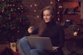 Beautiful woman using laptop computer, doing Christmas online shopping at home, paying with credit card Royalty Free Stock Photo