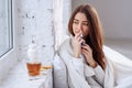 Beautiful woman using nasal spray. Close up of female feeling sick nose using sinus medication for blocked nose Royalty Free Stock Photo