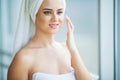 A beautiful woman using a skin care product, moisturizer or lotion and Skincare taking care of her dry complexion Royalty Free Stock Photo