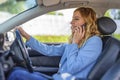 Beautiful woman using smartphone while driving car Royalty Free Stock Photo