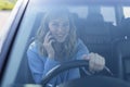 Beautiful woman using smartphone while driving car Royalty Free Stock Photo