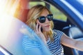 Beautiful woman using smartphone while driving car Royalty Free Stock Photo