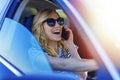 Beautiful woman using smartphone while driving car Royalty Free Stock Photo