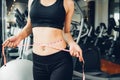 Beautiful woman using tape measuring waist, her is body slim after workout Royalty Free Stock Photo