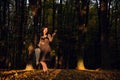 Beautiful woman in a vintage dress holding an umbrella and a leaf in a park on a sunny autumn day Royalty Free Stock Photo