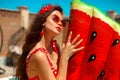 Beautiful woman in Vintage polka dots swimsuit with watermelon lilo float mattress by swimming pool on villa resort. Sexy girl Royalty Free Stock Photo