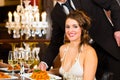 Beautiful woman and waiter in fine dining restaurant Royalty Free Stock Photo