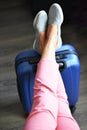 Beautiful woman waiting for delayed or connection flight with luggage in airport