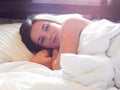 A beautiful woman wakes up in her bed. happy sunny morning Royalty Free Stock Photo