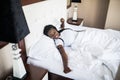 Beautiful afro american woman waking up in her bed, she is smiling and stretching Royalty Free Stock Photo