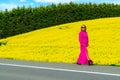 Beautiful women walking in amazing field of yellow rapeseed in the countryside. Canola oil plants Royalty Free Stock Photo