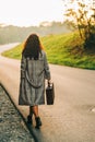 Beautiful woman walking away down the road Royalty Free Stock Photo