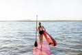 Woman with paddleboard on the pier outdoors